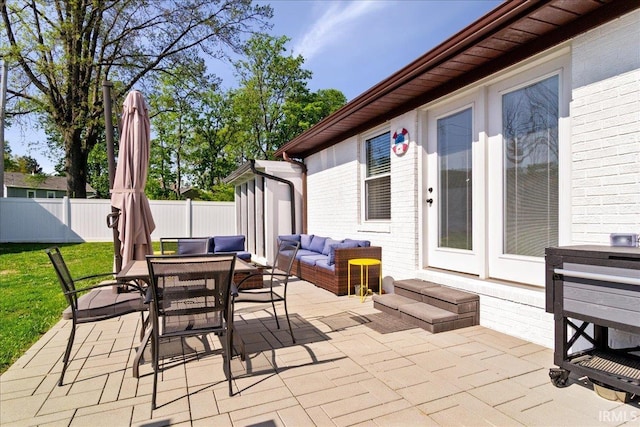 view of patio / terrace with entry steps, fence, outdoor dining area, and outdoor lounge area