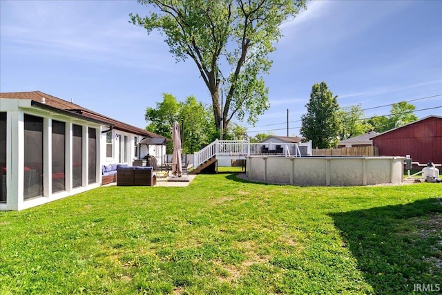 view of yard featuring fence and an outdoor pool
