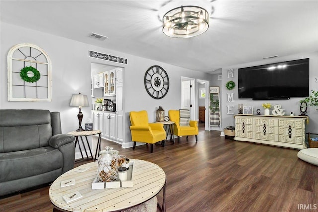 living room with visible vents, baseboards, and dark wood-type flooring