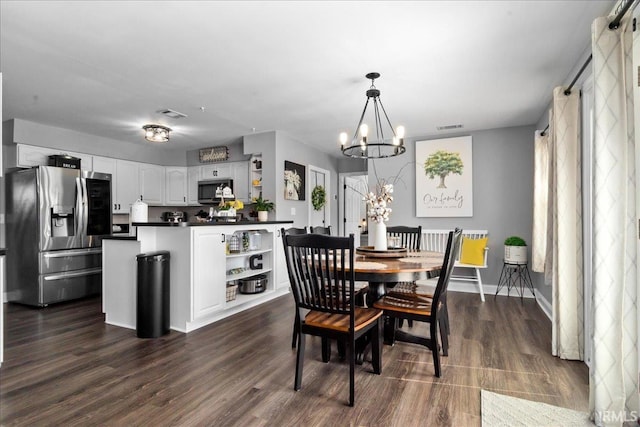 dining area with an inviting chandelier, baseboards, visible vents, and dark wood-type flooring