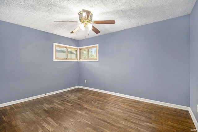 spare room with baseboards, ceiling fan, a textured ceiling, and wood finished floors