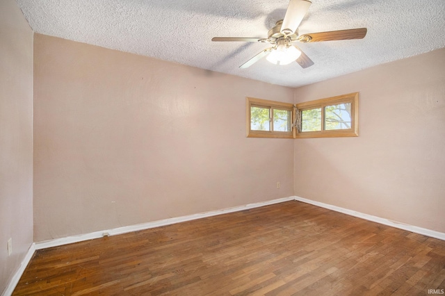 empty room featuring baseboards, a textured ceiling, ceiling fan, and wood finished floors