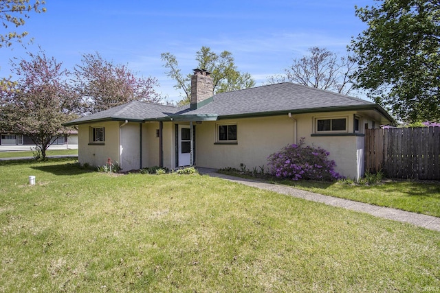 ranch-style home featuring fence, a shingled roof, stucco siding, a front yard, and a chimney