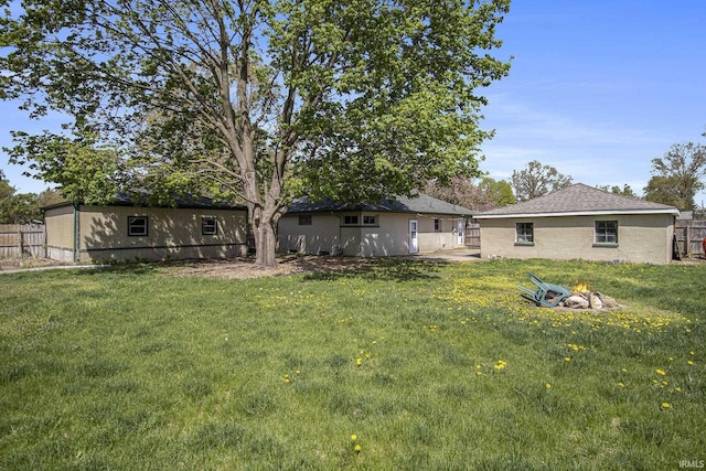 view of yard featuring a fire pit and fence