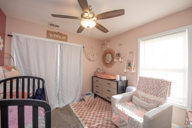 bedroom with ceiling fan, carpet flooring, and visible vents