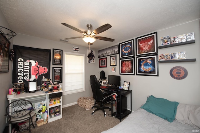 bedroom with visible vents, carpet floors, baseboards, ceiling fan, and a textured ceiling