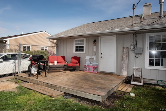 back of house featuring outdoor lounge area, fence, a wooden deck, roof with shingles, and board and batten siding