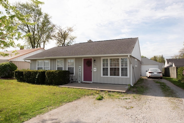 ranch-style house with a garage, a front lawn, roof with shingles, a chimney, and board and batten siding