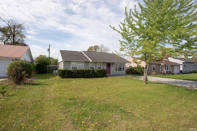 view of front facade with board and batten siding, concrete driveway, and a front lawn