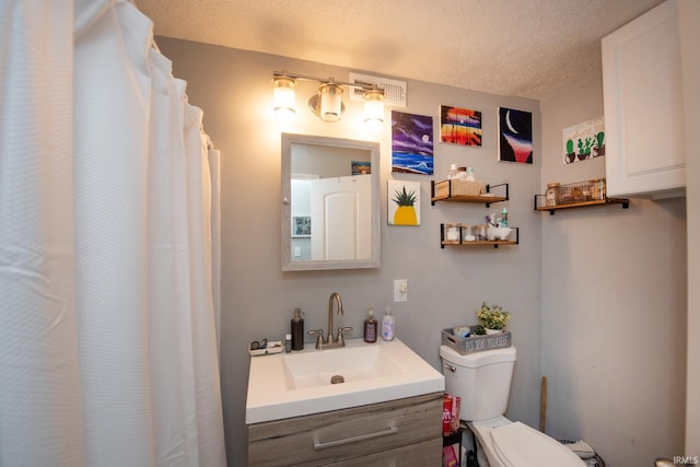 full bathroom featuring visible vents, a textured ceiling, toilet, and vanity
