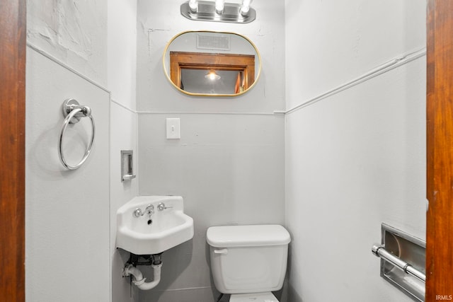 half bathroom with a sink and toilet