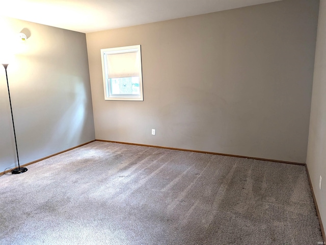 spare room with carpet floors and baseboards