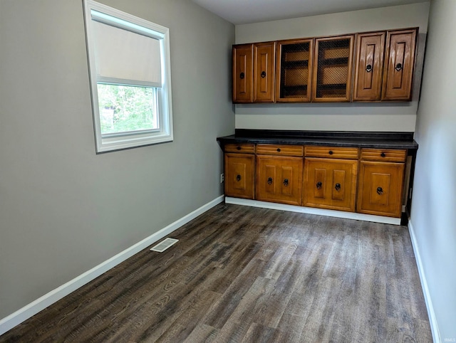 bar featuring baseboards, dark wood-style floors, and visible vents