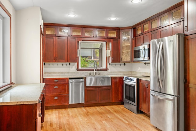 kitchen featuring recessed lighting, a sink, light wood-style flooring, and stainless steel appliances