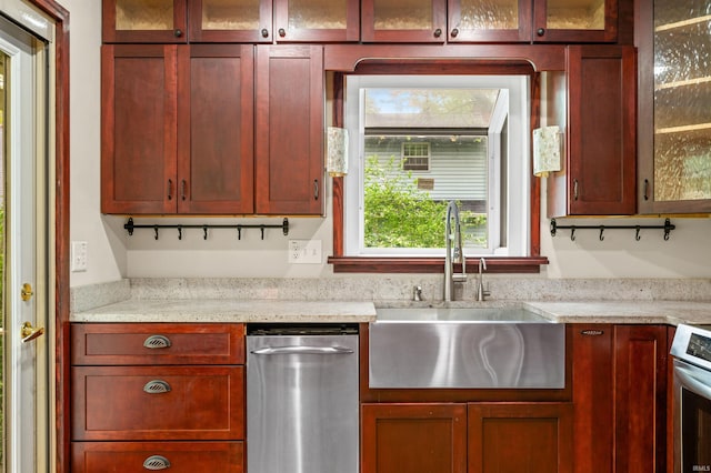 kitchen with glass insert cabinets, a sink, stainless steel range with electric stovetop, and reddish brown cabinets
