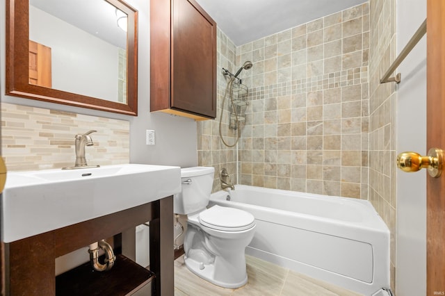 full bathroom with tasteful backsplash, toilet, and shower / washtub combination