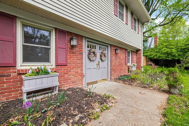 doorway to property with brick siding