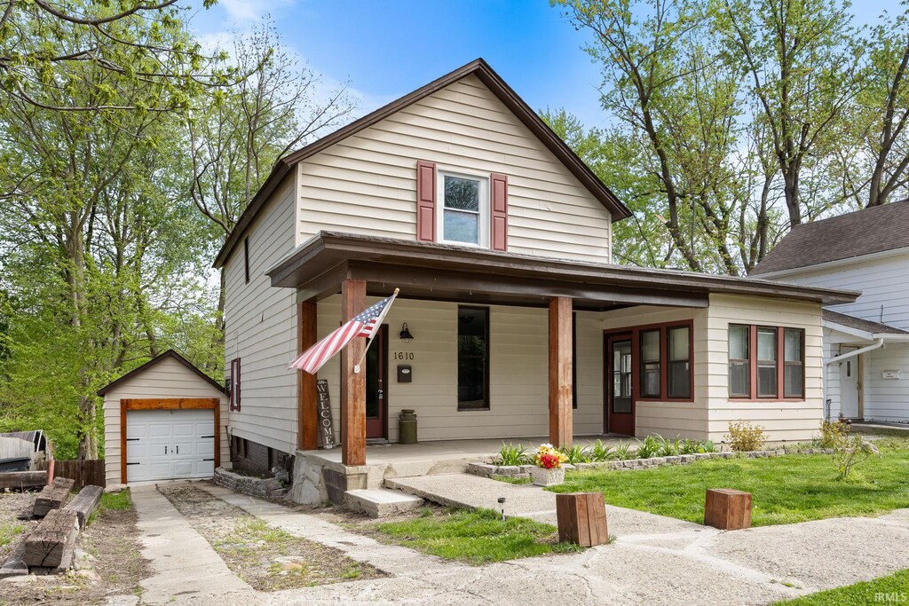1610 Columbia St, Lafayette, IN 47901 - view of front of home featuring covered porch, concrete driveway, an outdoor structure, and a garage
