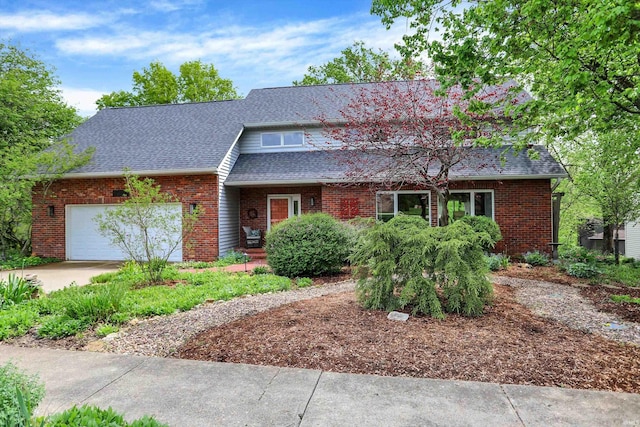 view of front of house featuring brick siding, a shingled roof, an attached garage, and concrete driveway