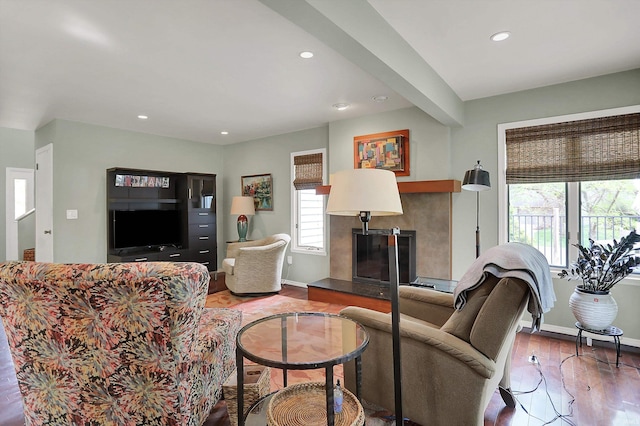 living area with recessed lighting, a fireplace, light wood finished floors, and a wealth of natural light