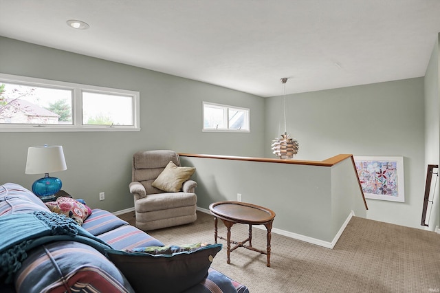 living area with baseboards and carpet