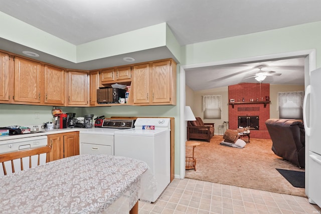 kitchen featuring light colored carpet, open floor plan, washer and dryer, and a fireplace
