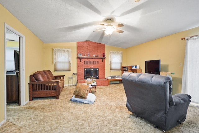 living area featuring carpet flooring, ceiling fan, a fireplace, baseboards, and lofted ceiling