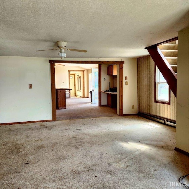 3566 W Sycamore Ln Unit 57, Columbia City, IN 46725 - unfurnished living room with carpet floors, a textured ceiling, ceiling fan, and stairway