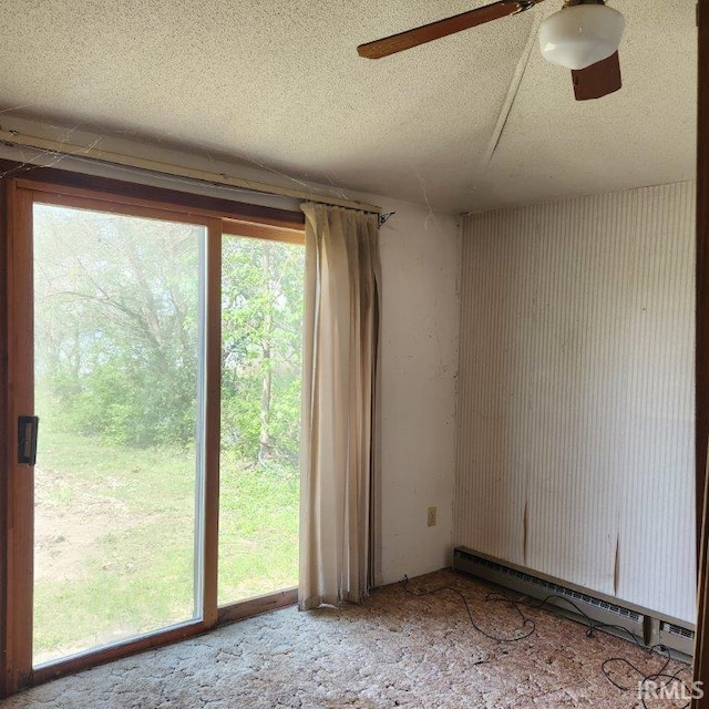 3566 W Sycamore Ln Unit 57, Columbia City, IN 46725 - empty room with a healthy amount of sunlight, a textured ceiling, a baseboard radiator, and ceiling fan