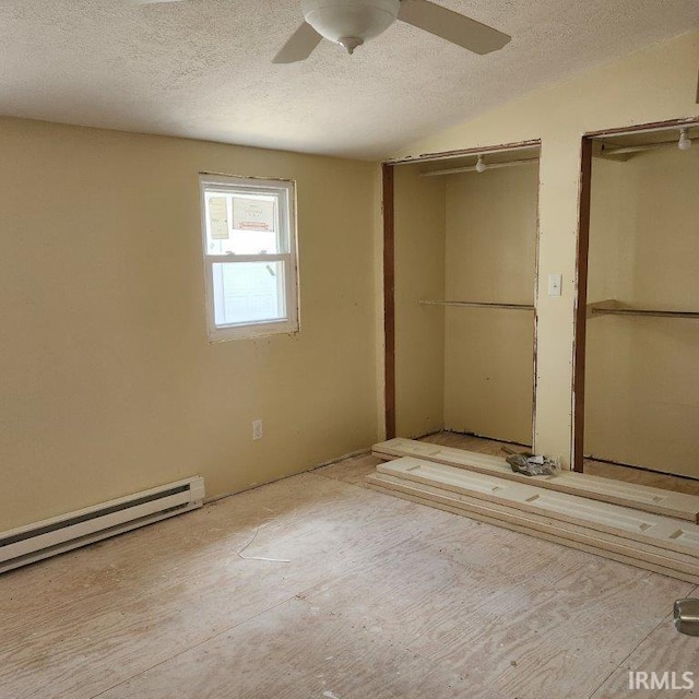 3566 W Sycamore Ln Unit 57, Columbia City, IN 46725 - unfurnished bedroom featuring multiple closets, a baseboard radiator, a ceiling fan, and a textured ceiling