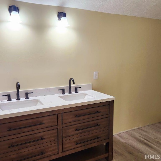 3566 W Sycamore Ln Unit 57, Columbia City, IN 46725 - bathroom featuring a sink, double vanity, and wood finished floors