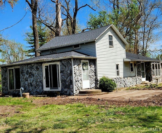 3566 W Sycamore Ln Unit 57, Columbia City, IN 46725 - traditional home with roof with shingles and stone siding
