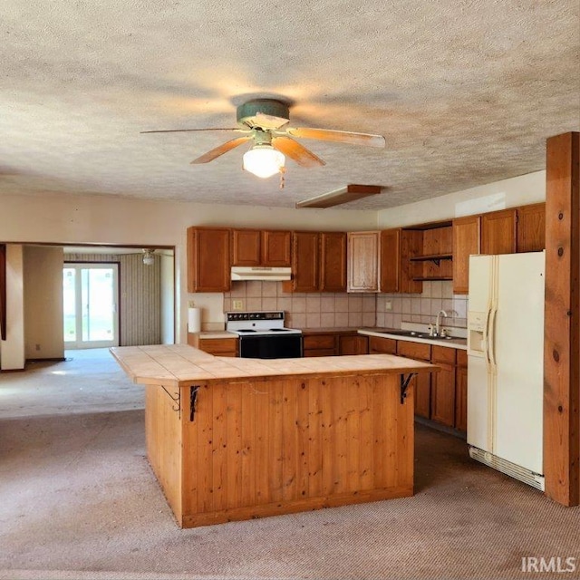 3566 W Sycamore Ln Unit 57, Columbia City, IN 46725 - kitchen featuring electric range oven, carpet floors, white fridge with ice dispenser, tile countertops, and under cabinet range hood