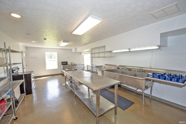 game room featuring a textured ceiling, recessed lighting, baseboards, finished concrete floors, and visible vents