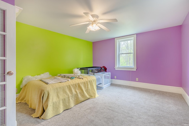 carpeted bedroom with baseboards and a ceiling fan