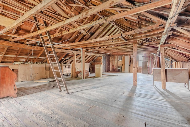 misc room with wood-type flooring and vaulted ceiling