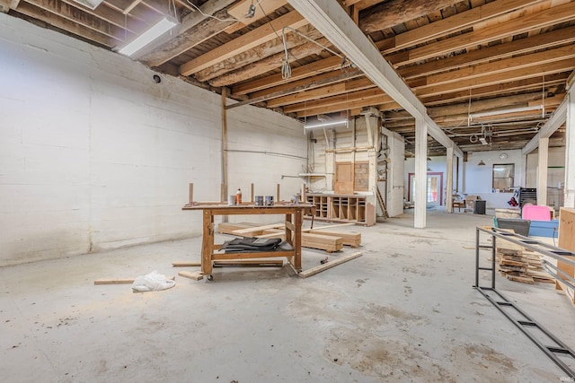 unfinished below grade area featuring a workshop area