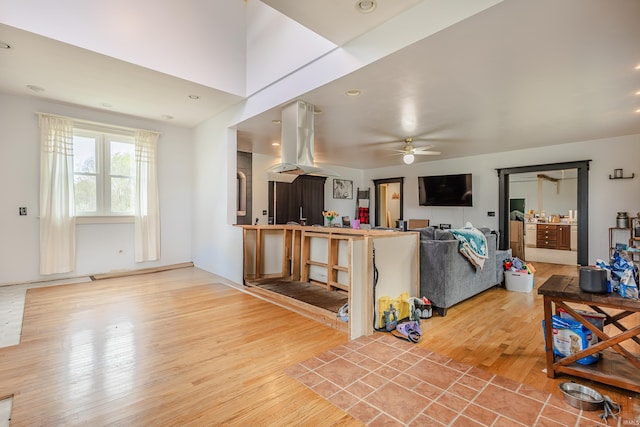 living room with a ceiling fan and wood finished floors
