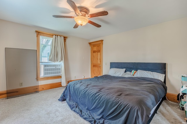 carpeted bedroom with baseboards, a ceiling fan, and cooling unit