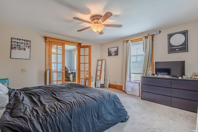 carpeted bedroom featuring french doors and a ceiling fan