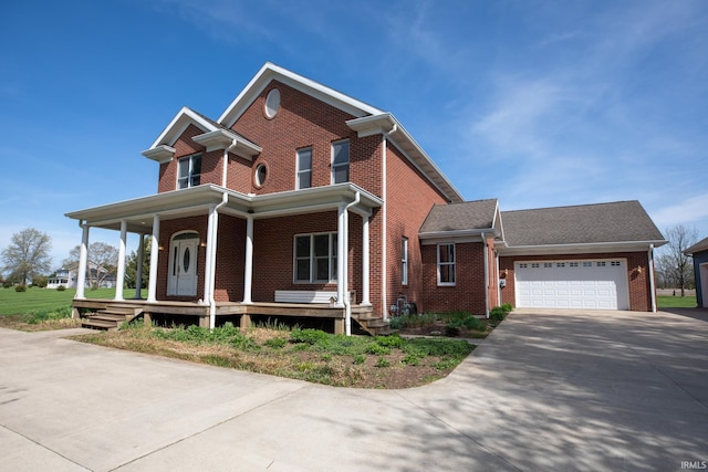 10220 6b Rd, Plymouth, IN 46563 - view of front of property featuring a porch, concrete driveway, brick siding, and a garage