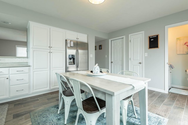 dining room featuring wood finish floors and baseboards