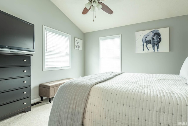 bedroom with ceiling fan, light carpet, baseboards, and lofted ceiling