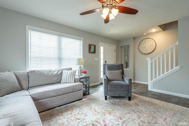 living area with a ceiling fan, baseboards, recessed lighting, wood finished floors, and stairway