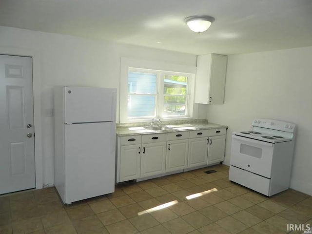 414 17th St, Bedford, IN 47421 - kitchen featuring light countertops, white cabinetry, and white appliances