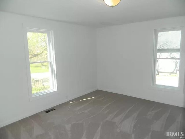 414 17th St, Bedford, IN 47421 - unfurnished room featuring dark colored carpet and visible vents