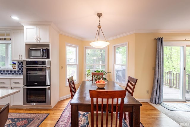 dining area featuring light wood-style floors and a healthy amount of sunlight