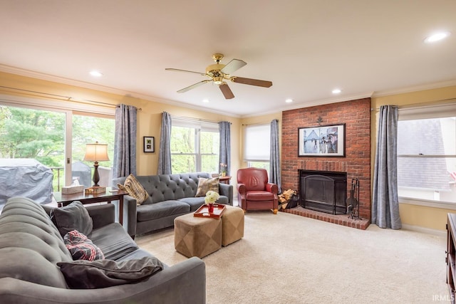 living area featuring light carpet, a brick fireplace, recessed lighting, a ceiling fan, and ornamental molding