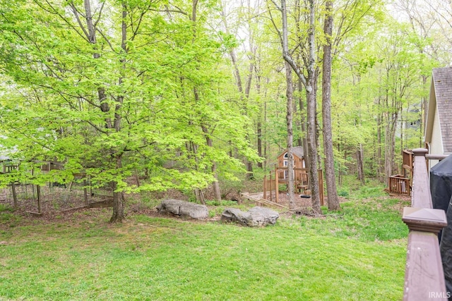 view of yard with an outdoor structure and a forest view