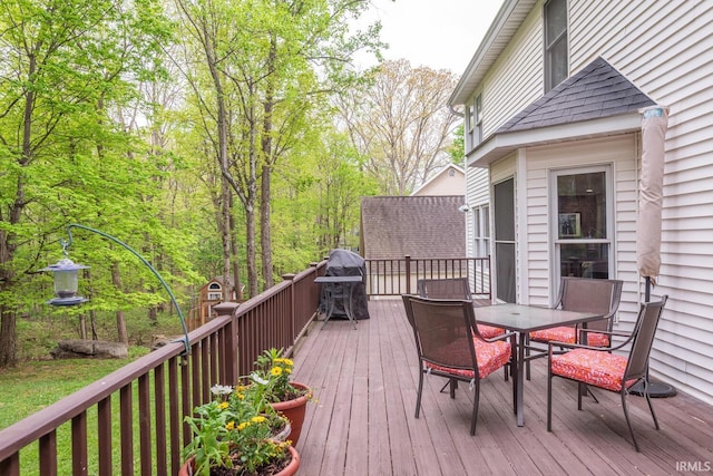 deck featuring outdoor dining area and area for grilling